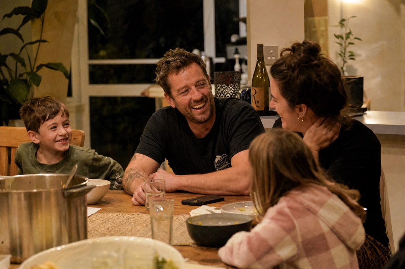 Plumber present with his family at dinner, phone away